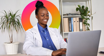 A medical professional looking at laptop