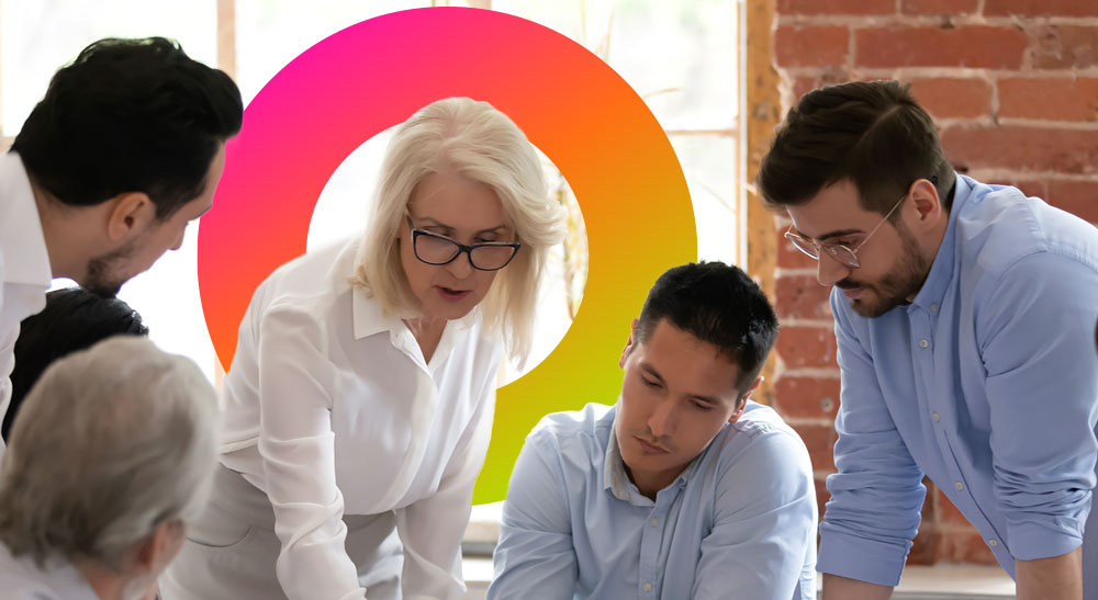 A group of people in professional attire engage in discussion