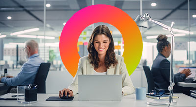 A woman working at a desk with a laptop