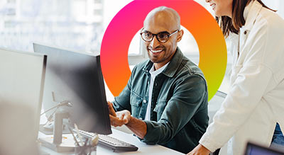 Two employees working on a computer in an office aws case study thumbnail