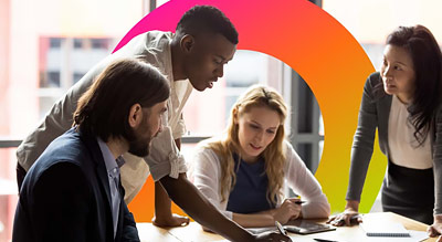 A group of professionals in a meeting sit around a table