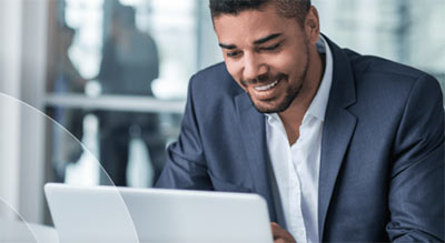 Male employee in Blue blazer on a laptop