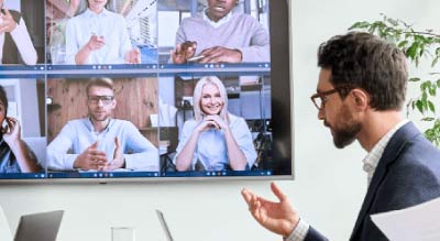 Man in conference room on video call