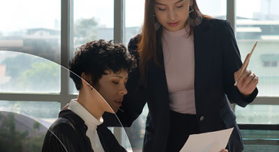 Two women looking over a piece of paper