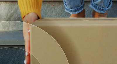 A person carrying a cardboard box