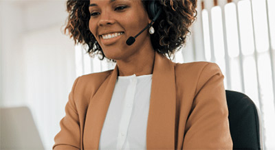 African American Woman in an office setting with headset on