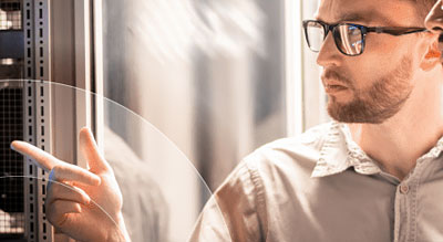 Two men investigate components in data center