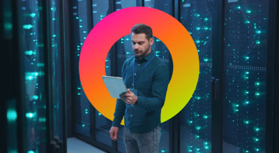 Man working in server room and looking on ipad