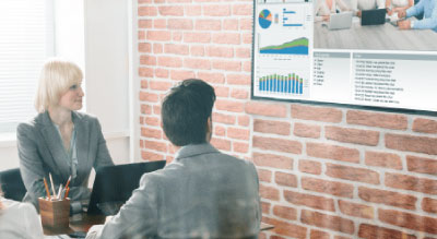 People in a meeting room watching a presentation