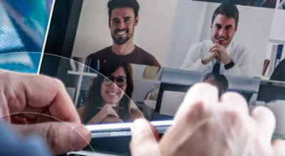 Man remotely meeting with coworkers on a laptop