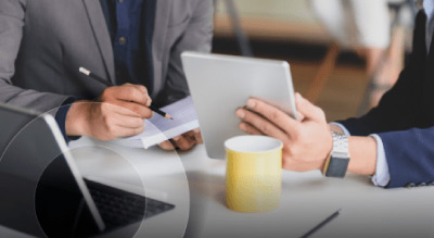 Two people having a meeting and looking at tablet