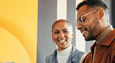 An african American woman and man in an office with yellow wall