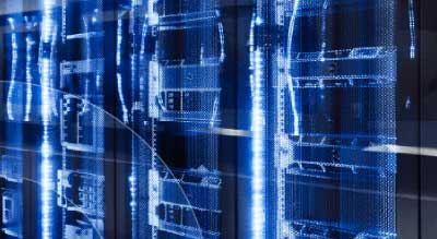 A futuristic server room with blue schematic diagrams overlaying the hardware