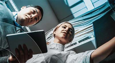 Man and woman working in server room thumbnail
