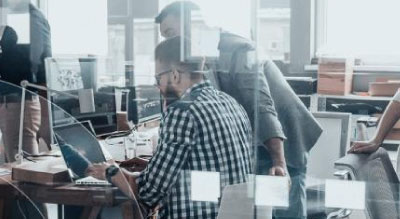 Someone on the computer inside an office