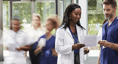 Two medical professionals review documents