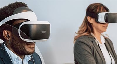 A man and a woman wearing a VR headset