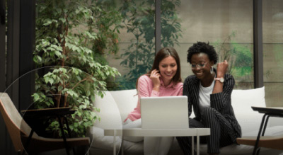 Two women working on laptop together