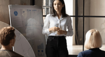 A woman holds a presentation infront of three people