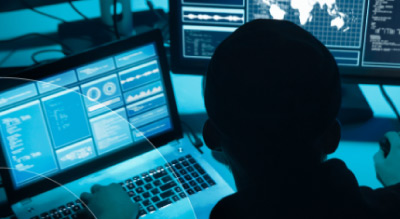 Man working in the dark on computers thumbnail