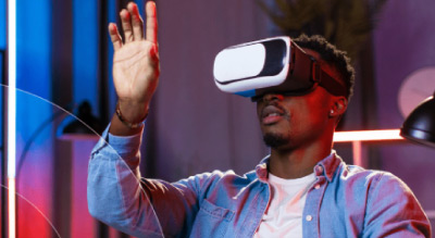 Man raises hand wearing VR headset