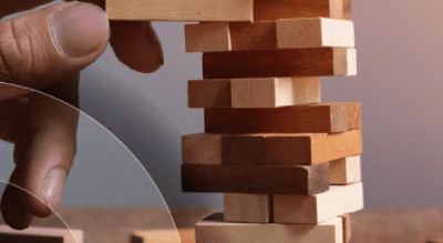 Close up of a hand stacking wooden blocks
