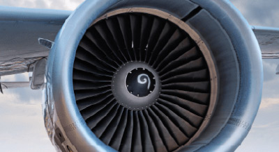 Close up of an airplane engine and wing in the sky