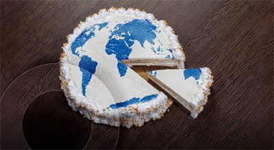 A cake with a blue and white world map design on it, with a slice cut out.