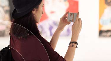 Woman at an art gallery holding object in her hands