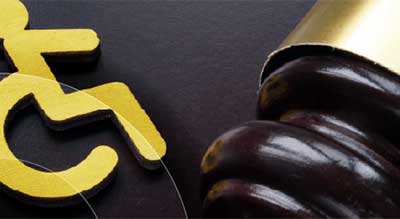 A golden wheelchair symbol next to a gavel