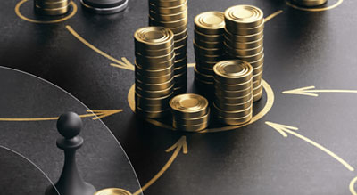 Stacks of coins next to chess pieces