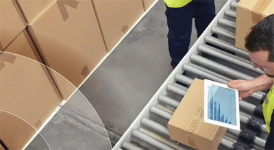 boxes on conveyer belt man on tablet
