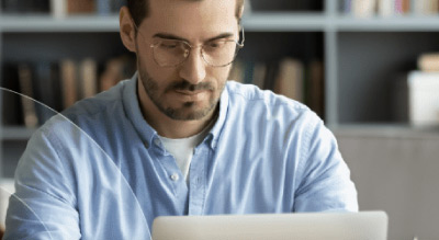 A person working on a laptop in a home office setting