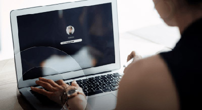 Women on laptop looking at login screen