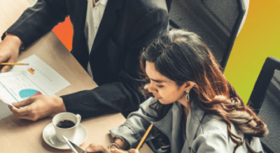 Man and woman sitting at table for office meeting