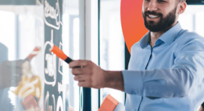 Man reviewing information on a dry erase board