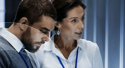 A man and a woman examine a data center