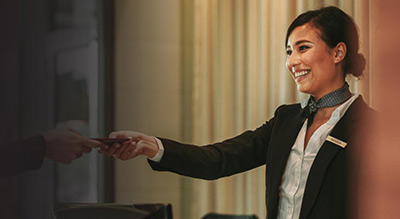 Woman handing customer their card back 