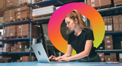 Girl working on laptop in warehouse