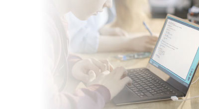 Child on laptop in classroom thumbnail