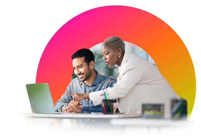 Person showing something on a laptop to coworker