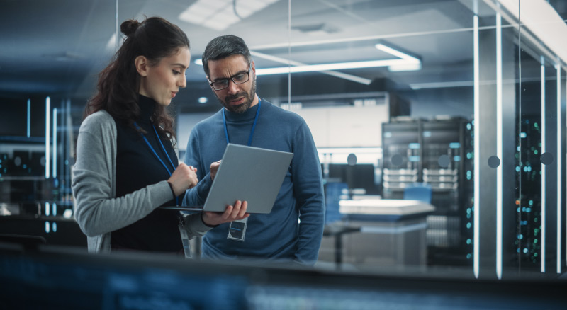 Two people discussing in a modern server room