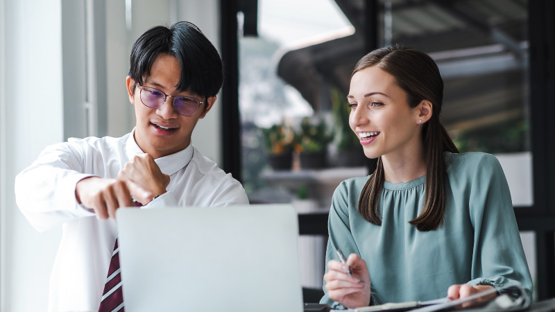 Man and woman working on a laptop together