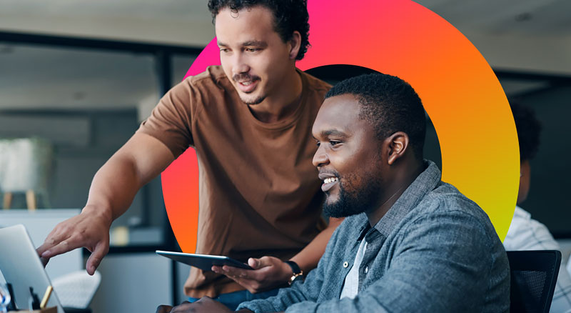 Two men working together on a computer