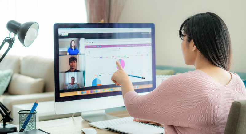 Woman talking to her colleagues about plan in video conference