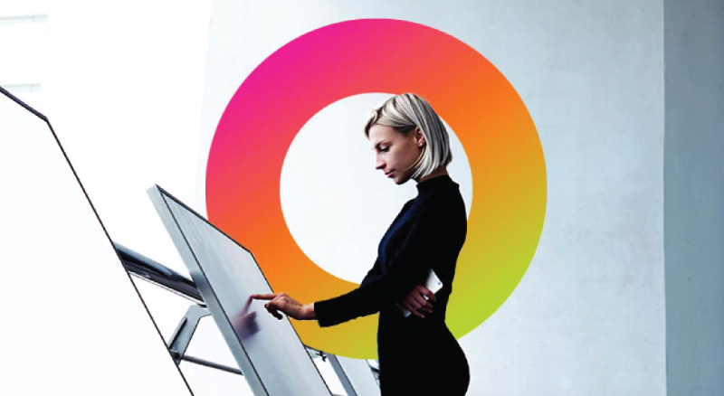 A person interacting with a large touch screen display