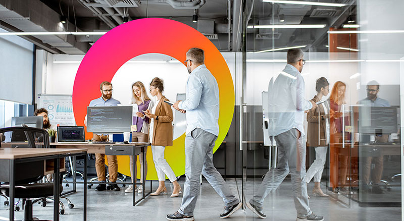 A modern office space where people are walking and engaging in work-related activities