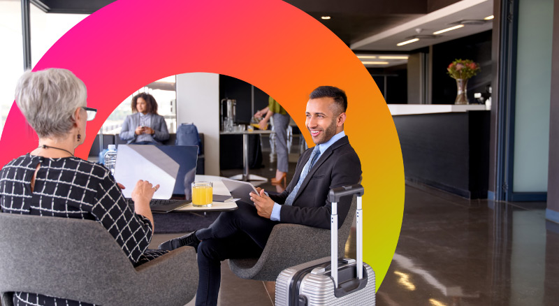 Two people sitting in a modern office lobby