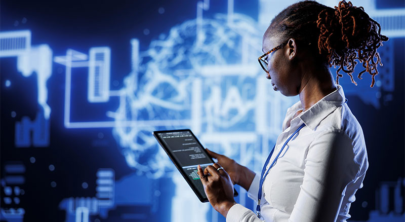 A woman in a white shirt holding a tablet computer, displaying information.