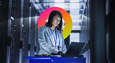 Woman using a computer in a data center room